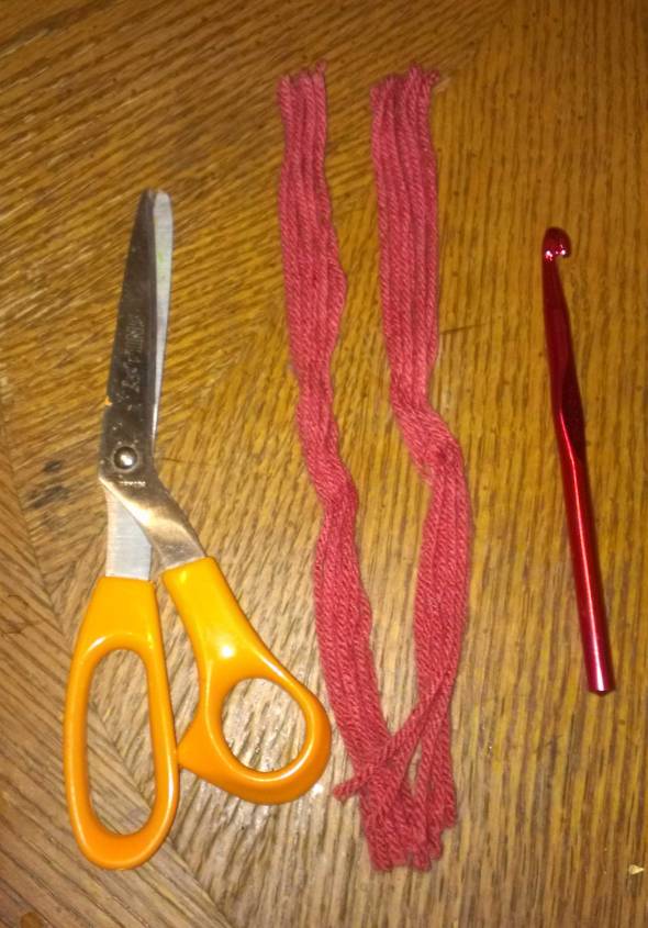 Your tools: scissors, your fringe, which I advise pre-cutting before you sit down to add it, and a crochet hook (I used a size N - 9.00 mm
